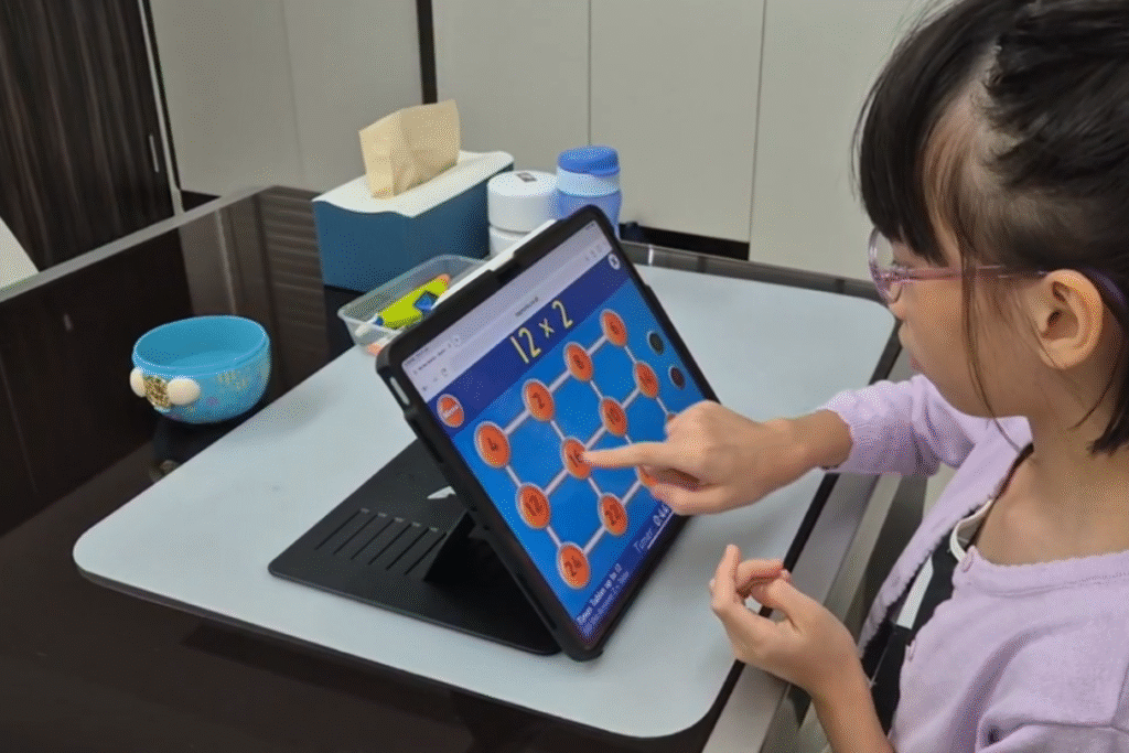 pecial needs tutor in Singapore guiding student during 1-to-1 special needs tuition session using visual learning tools.