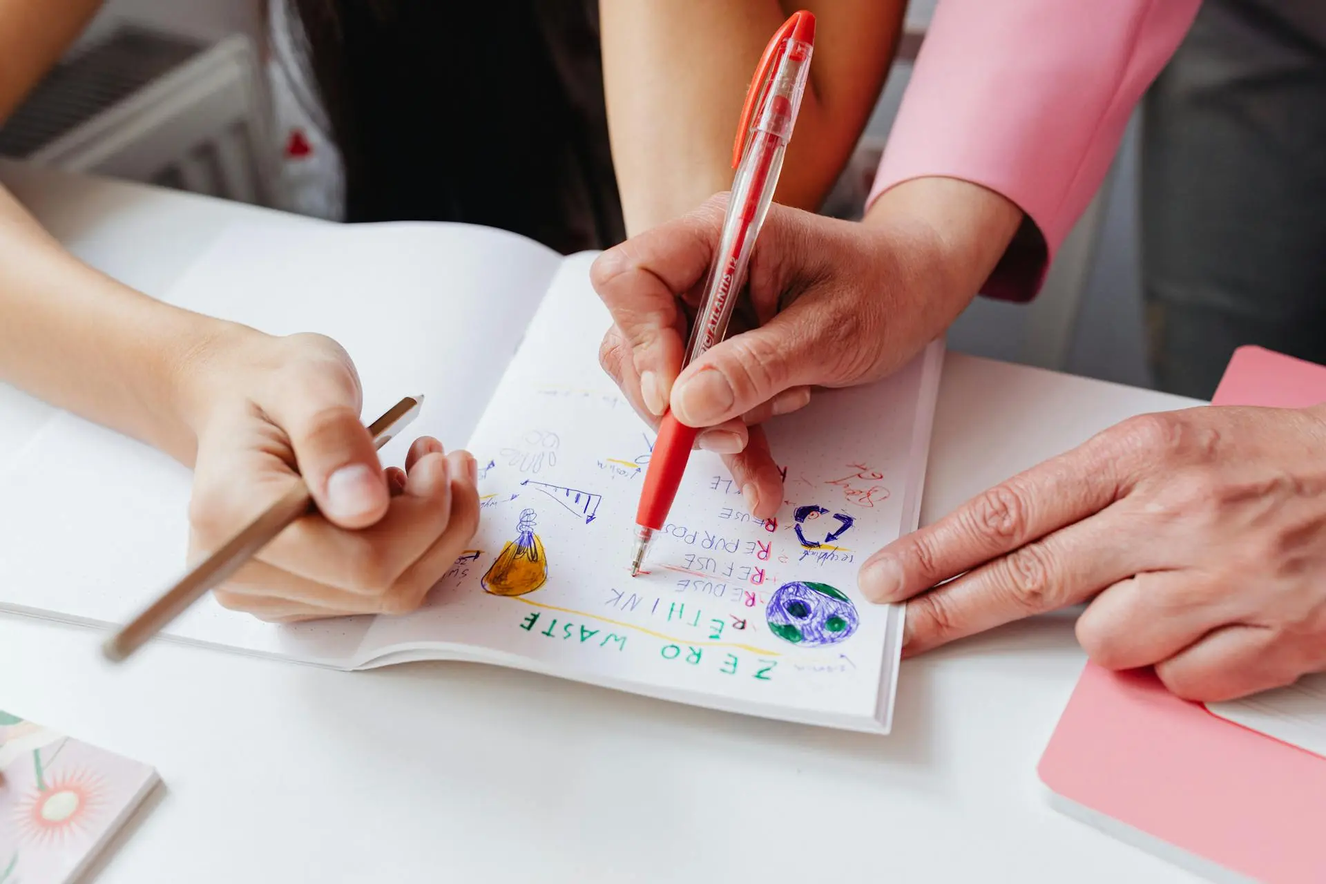 Child using kinesthetic learning through a hands-on activity with guidance from an adult